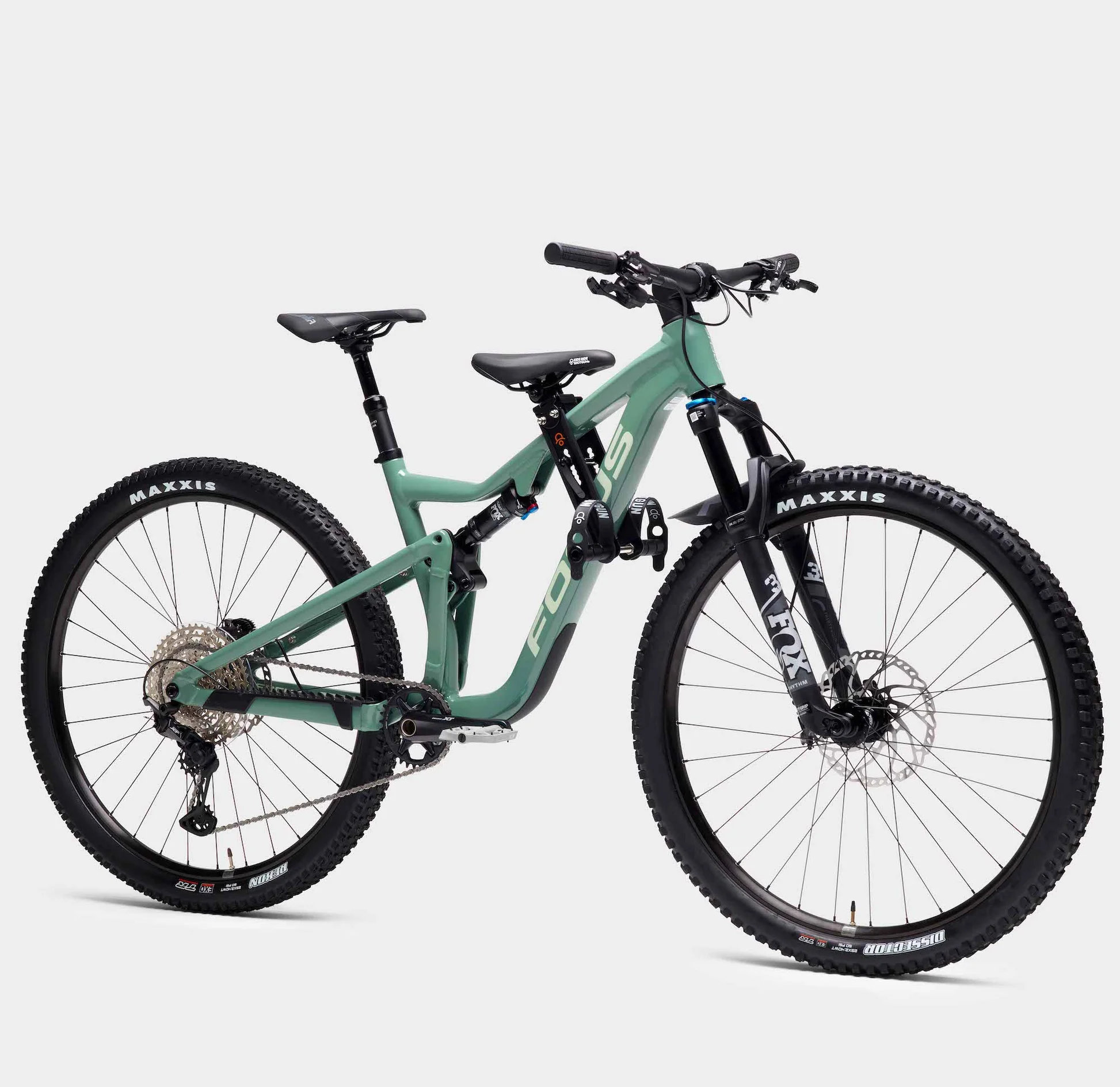 green full suspension bike with a small kids seat attachment on the top tube